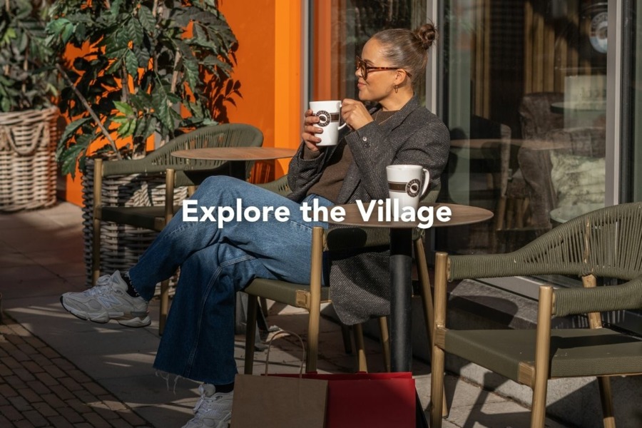 A woman enjoying coffee on the Espresso House terrace at Helsinki Outlet
