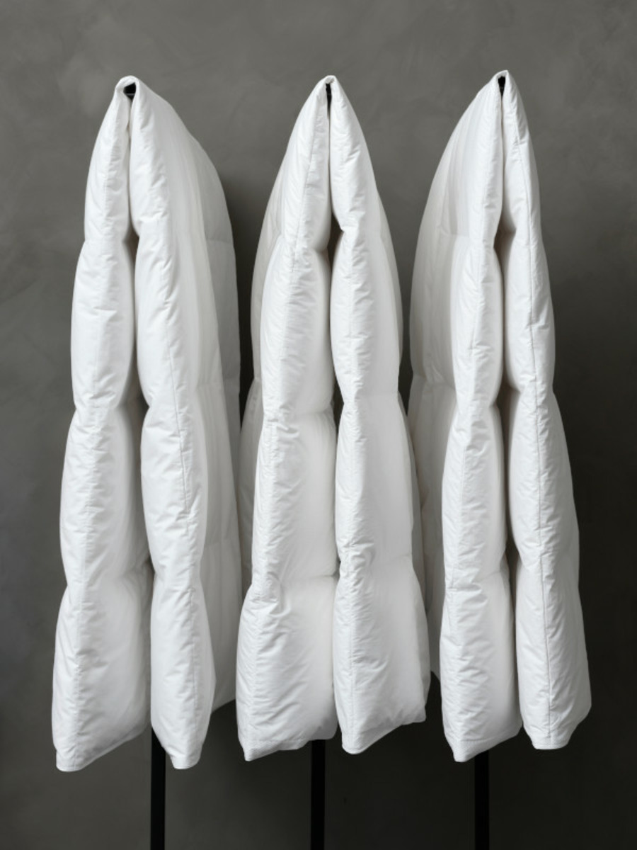 Three high-quality Tempur blankets are hanging on wall hooks.