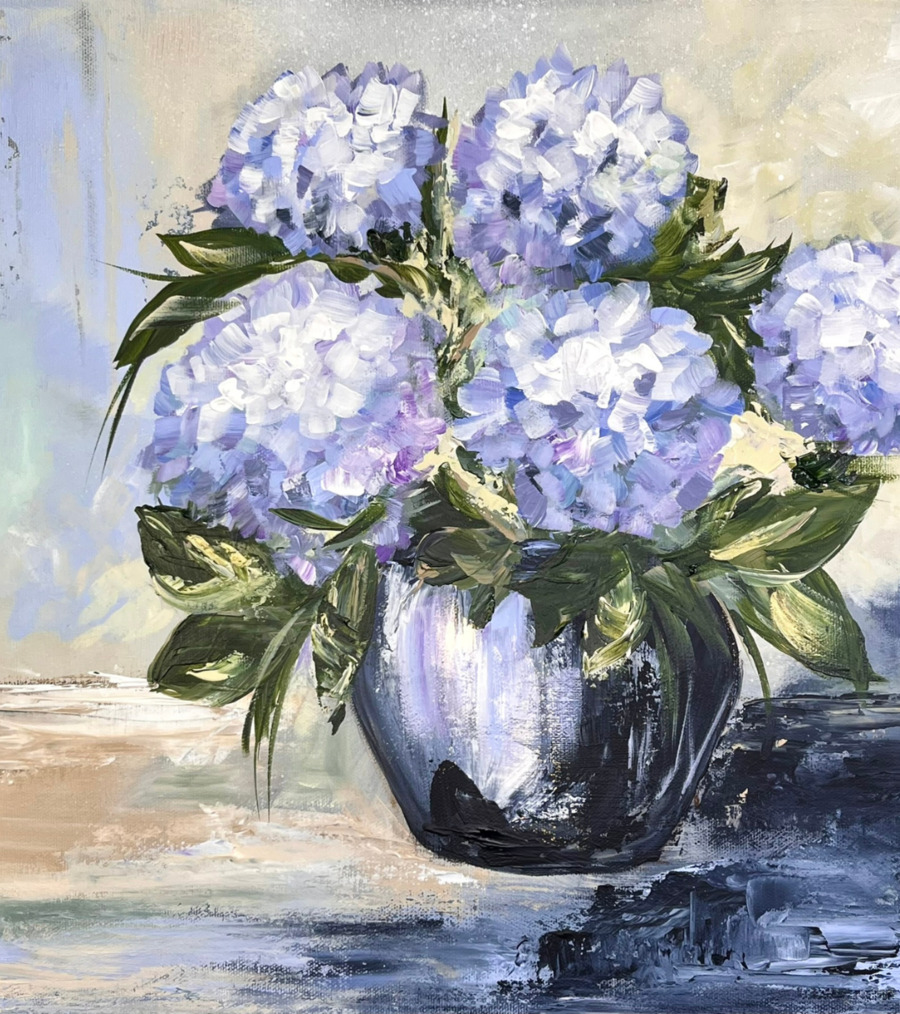 Artist of May A flower painting by the artist of the month. An expressive painting of a bouquet of light purple hydrangeas in a round, dark vase. The flowers are depicted with bold, textured brushstrokes, and green leaves frame the blossoms. The background is abstract, with soft blends of beige, blue, and grey tones, creating a calm and artistic atmosphere.
