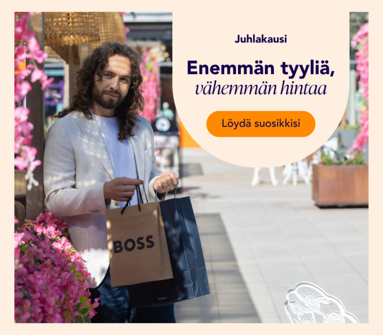 Mies ostoksilla kesäisesti koristellussa Helsinki Outletissa ostoskassit käsissään.