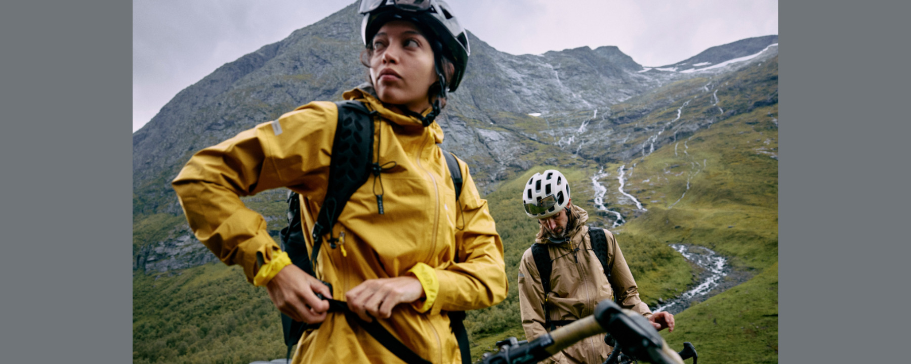 A woman and a man are cycling in the fells