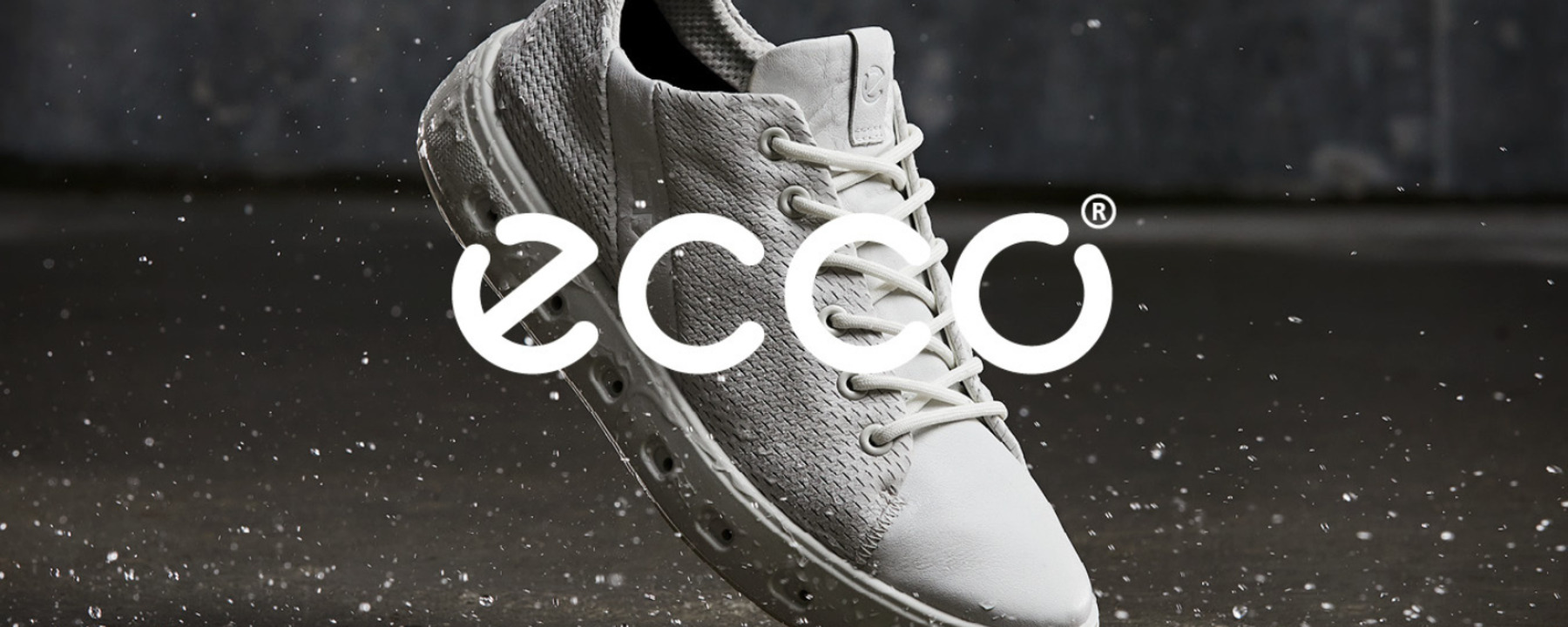 White leather sneaker on a black background. Water drops in the picture.