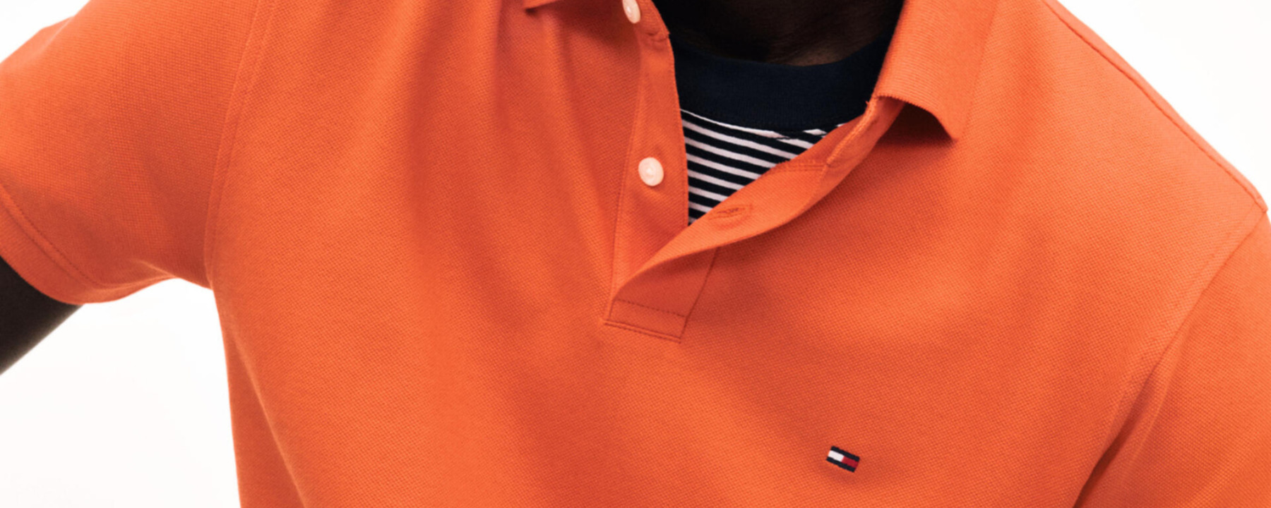 a man wearing an orange shirt