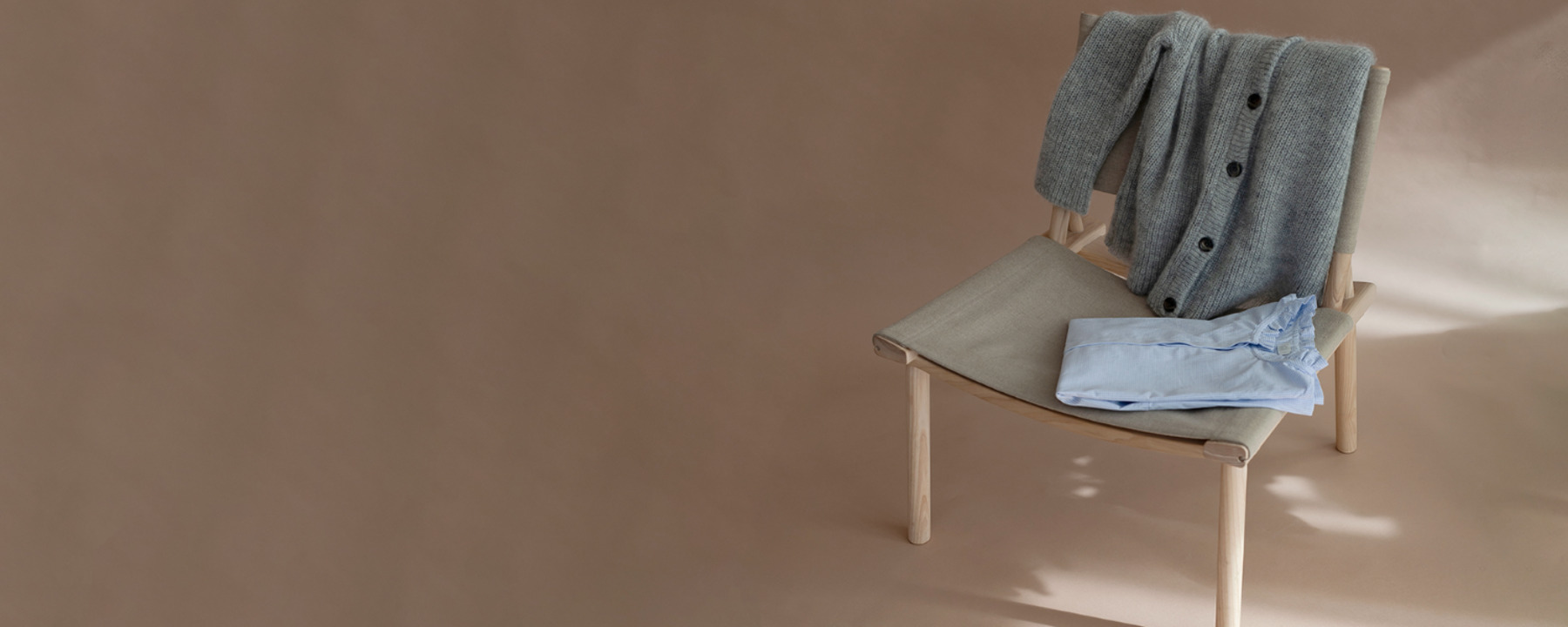 a chair with a cardigan and a shirt on it