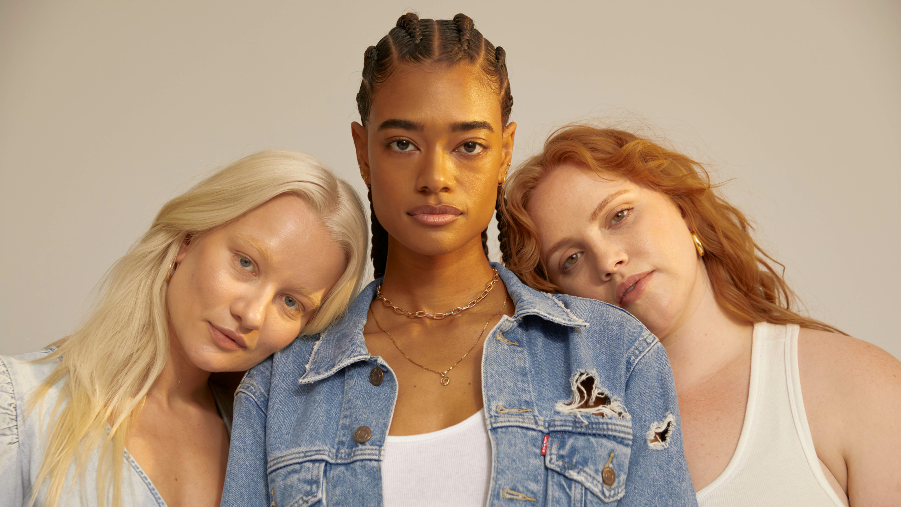 three women leaning on each other's shoulders