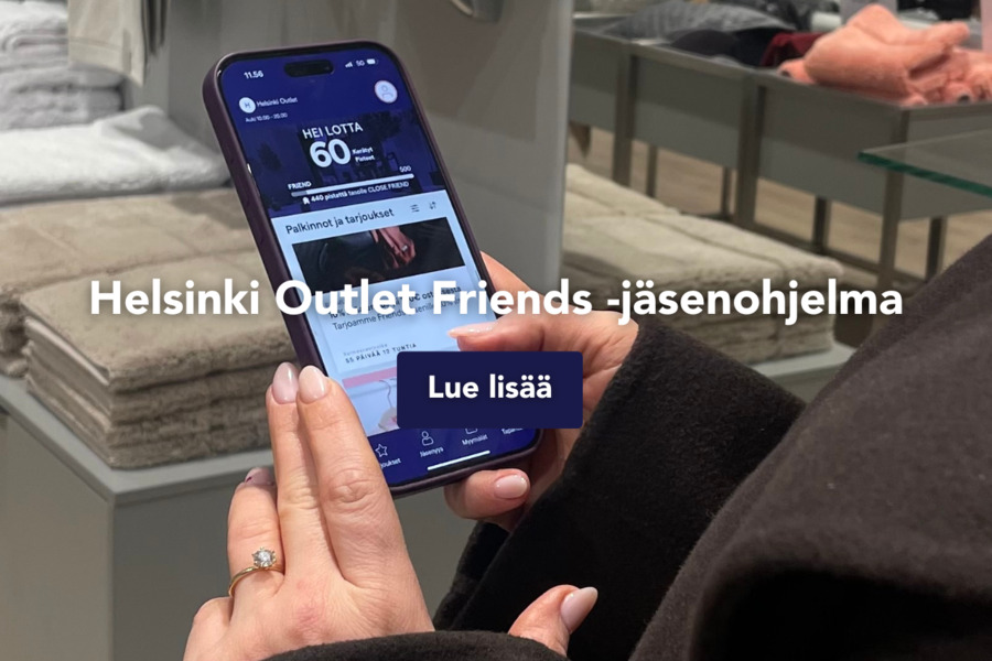 Asiakas selaa Helsinki Outlet Friends -sovellusta puhelimellaan