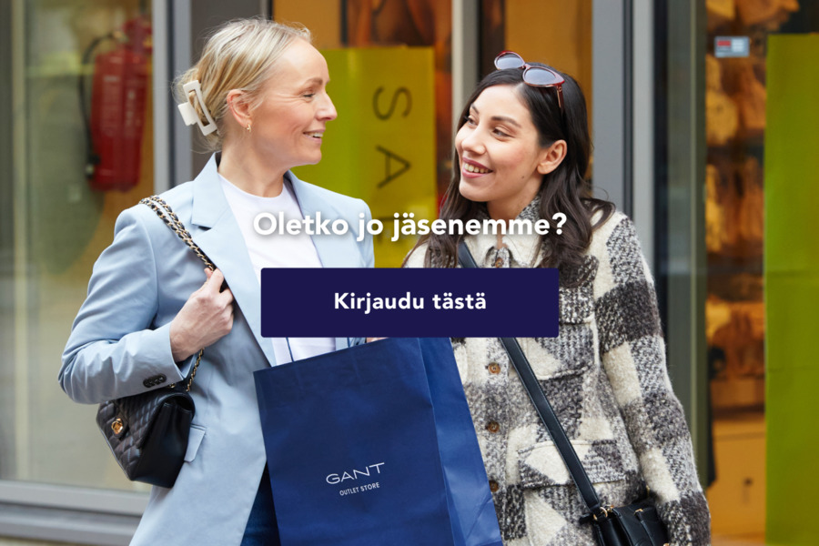 Kaksi naista hymyilee toisilleen ulkona ostoskeskuksen edessä. Toinen kantaa sinistä GANT Outlet Store -ostoskantokassia. Kuvan päällä teksti: "Oletko jo jäsenemme? Kirjaudu tästä".