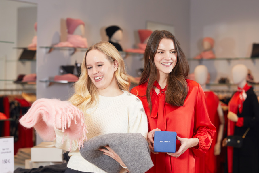 Two women shopping for Christmas gifts in the shopping village