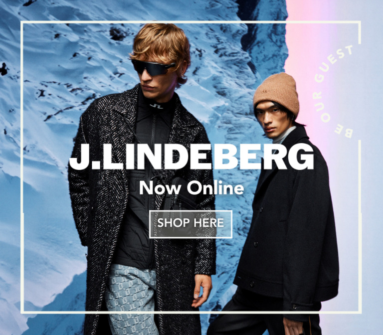 Two men wearing J.Lindeberg outfits in a snowy background.