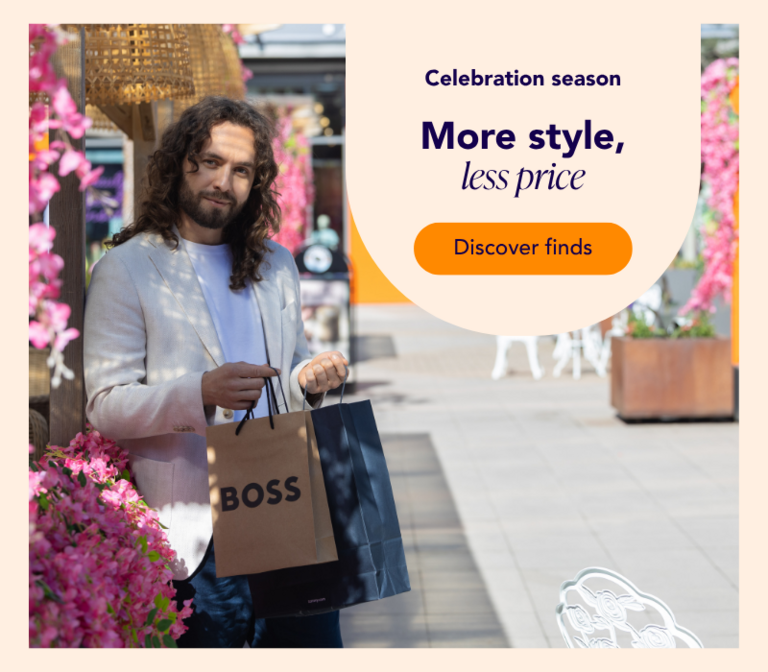 A man shopping at the summer-decorated Helsinki Outlet with bags in his hands.