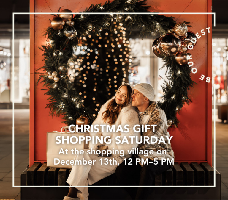 A couple visiting Helsinki Outlet on a late winter night, with Christmas lights behind her