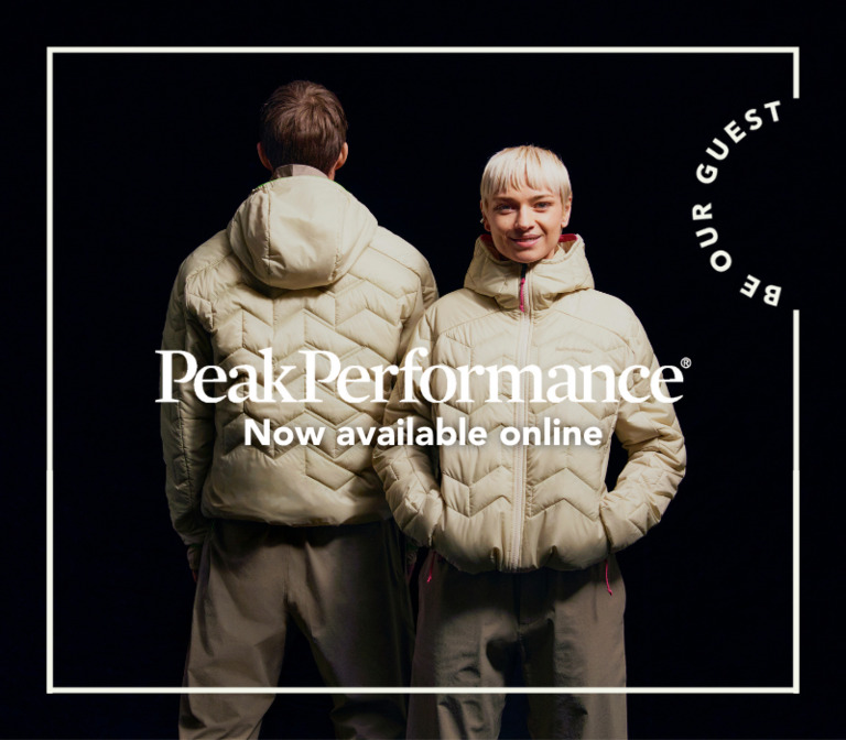 A man and a woman in ivory Peak Performance jackets on a black background