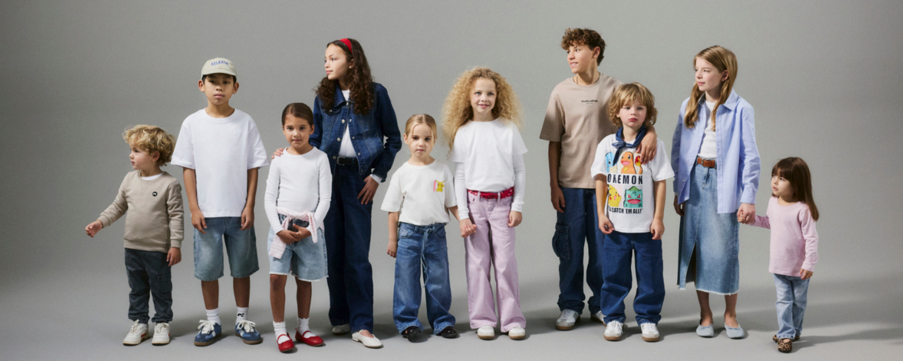 Children of different ages standing in a row wearing trendy clothes