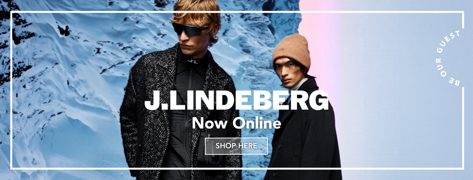 Two men wearing J.Lindeberg outfits in a snowy background.